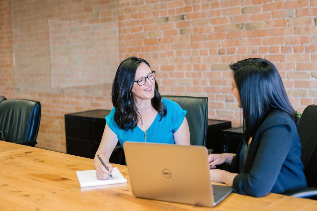 Two women talking about business